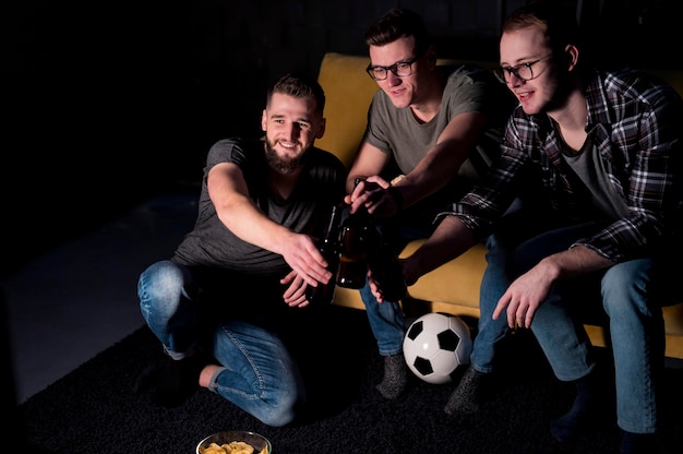 Free photo male friends watching sports on tv together