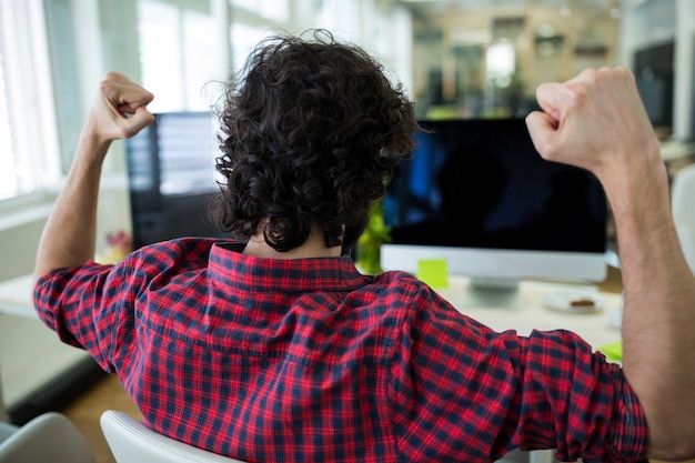 Free photo male graphic designer cheering in office