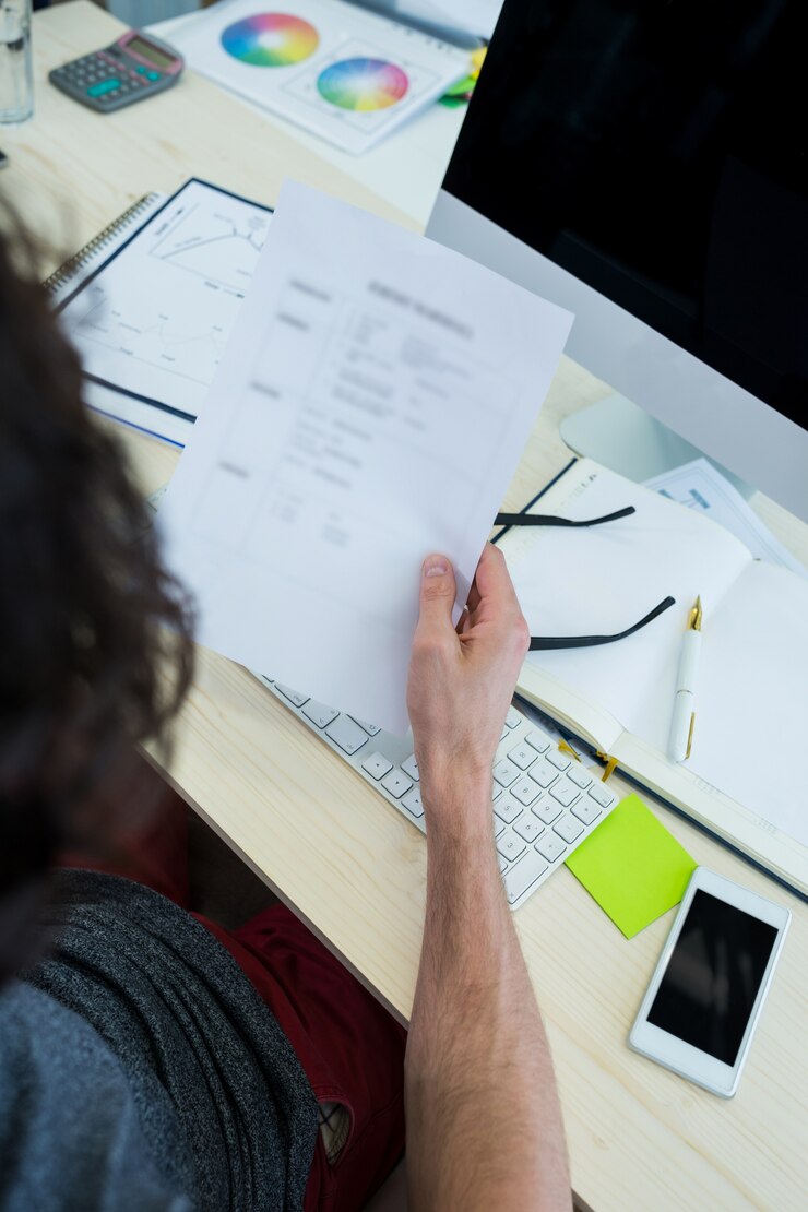 Free Photo male graphic designer looking at document