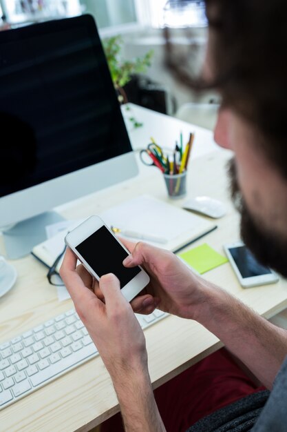 Male graphic designer using mobile phone