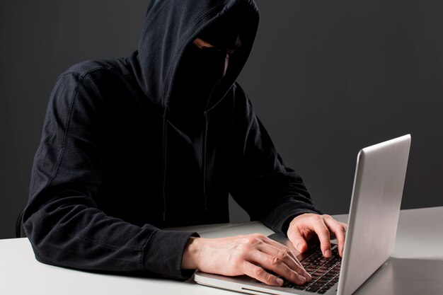 Male hacker with laptop