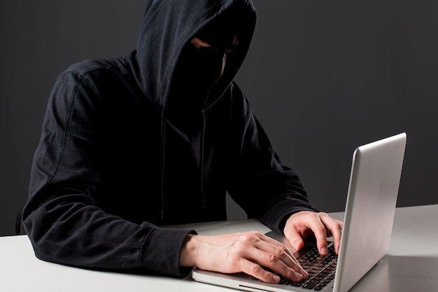 Male hacker with laptop