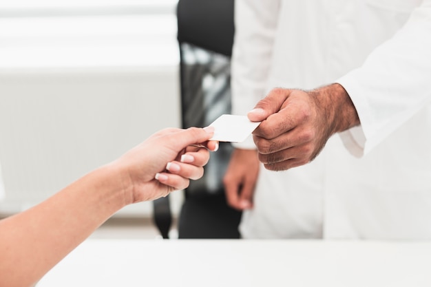 Male hand giving a white card