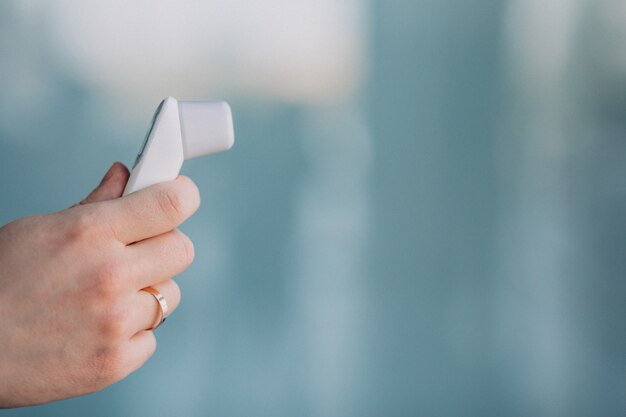 Male hand holding electro thermometer