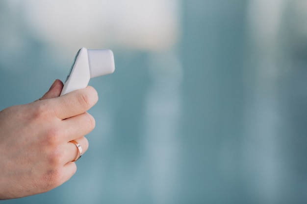 Male hand holding electro thermometer