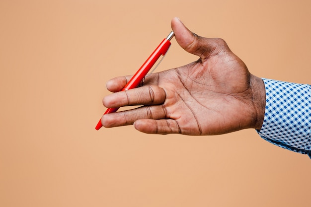 Male hand holding pencil, isolated