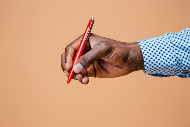 Male hand holding pencil, isolated