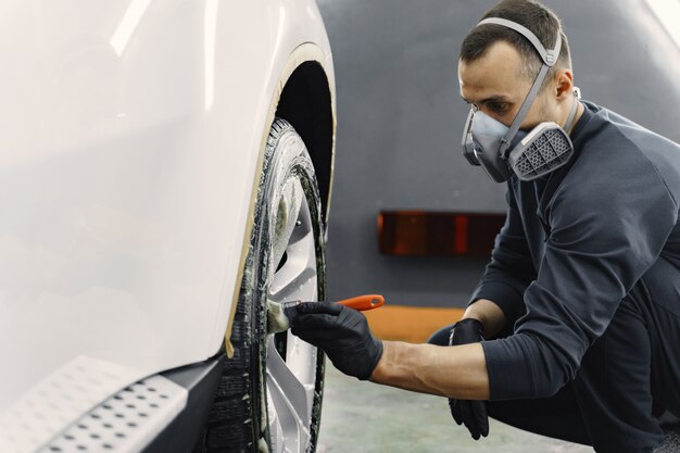 Male hand with foam sponge washing car