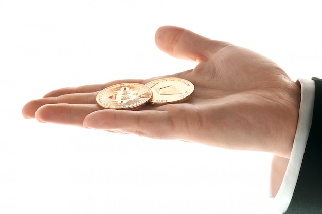 Male hand with golden bitcoin coins