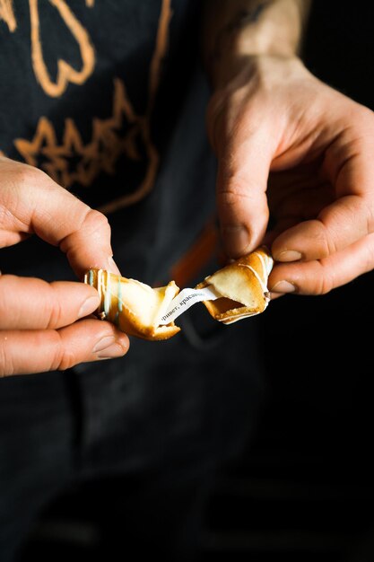 male hands breaking fortune cookie