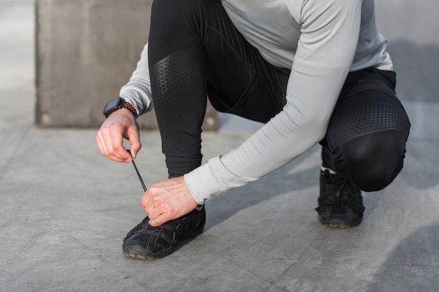 Male hands tying his laces