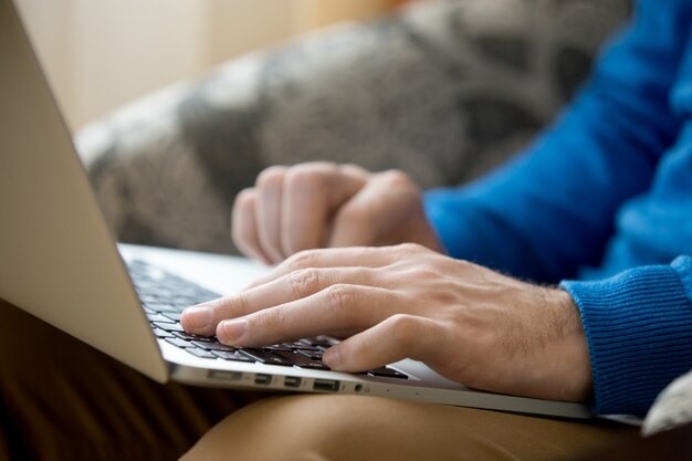 Male hands with laptop close-up