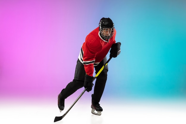 Free photo male hockey player with the stick on ice court and neon gradient space