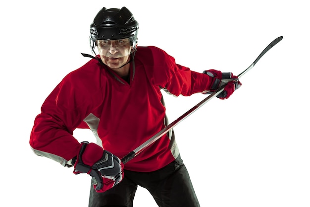 Free photo male hockey player with the stick on ice court and white background.