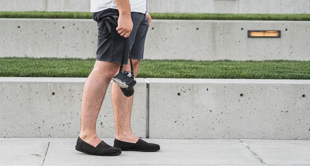 Male holding a camera on vacation