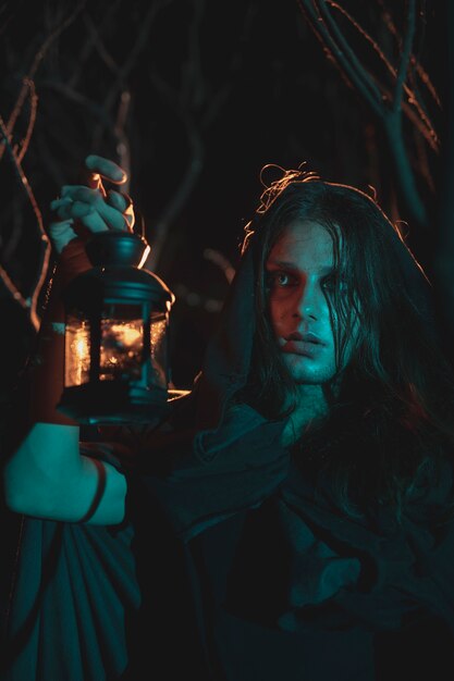 Male holding a lantern in the night