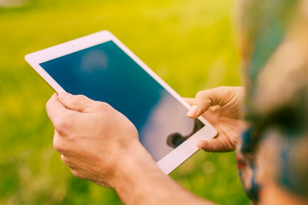 Male holding tablet in rural