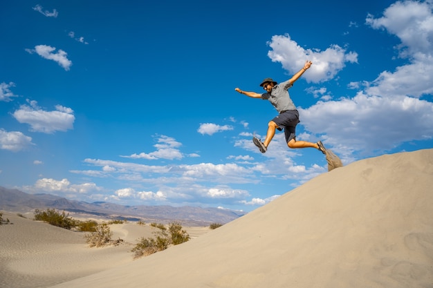 米国カリフォルニア州デスバレーの砂漠でジャンプする男性