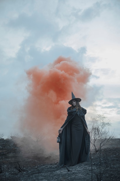 Free photo male mage in black clothes with red fog