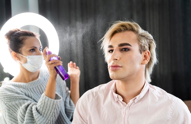 Male make-up look using hair spray