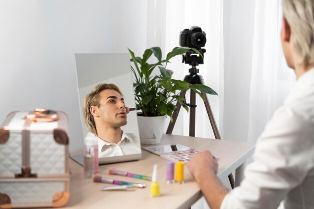 Male make-up look using a make-up brush