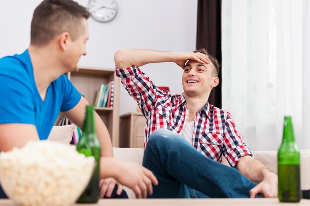 Male meeting with beers and popcorn