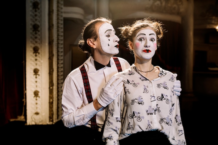 Free Photo male mime standing behind the surprised female mime