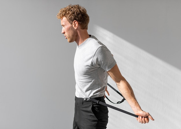 Free photo male model holding his suspenders