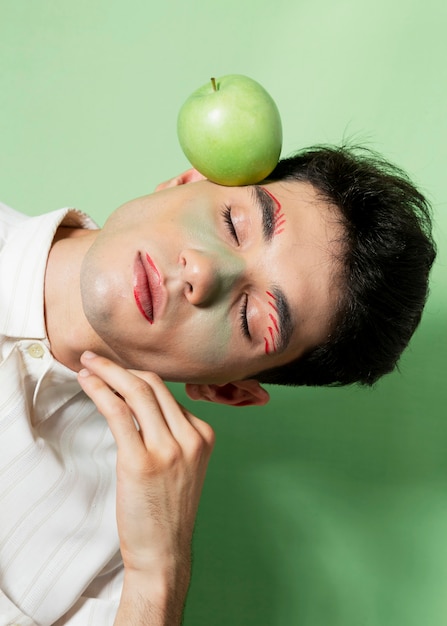 Male model posing with apple