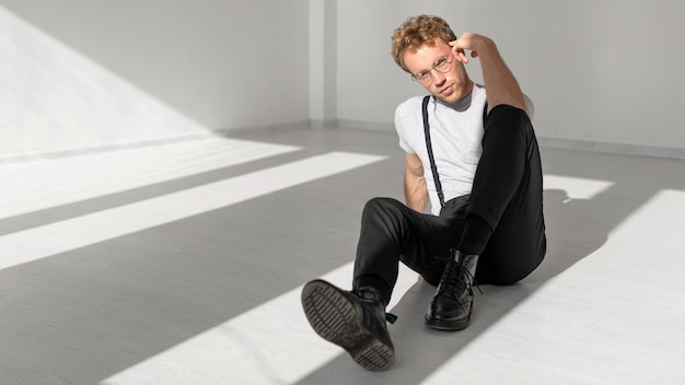 Male model sitting on the floor long shot