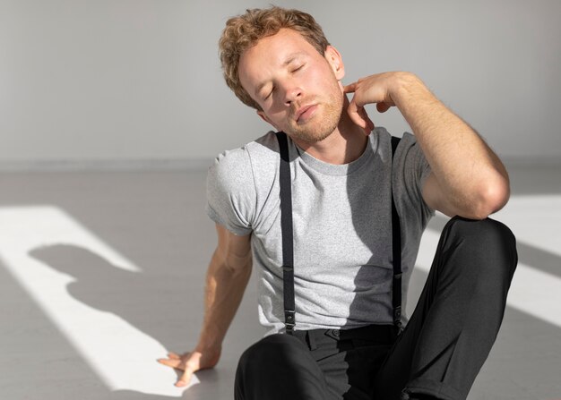 Male model sitting on the floor in studio