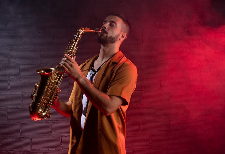 Free Photo male musician in fog playing the saxophone