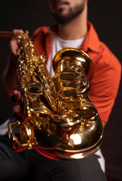 Male musician holding saxophone