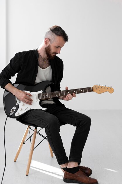 Male musician playing electric guitar