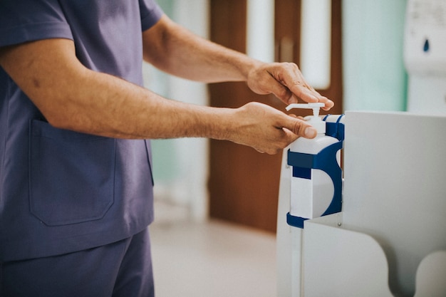 Male nurse disinfecting his hands