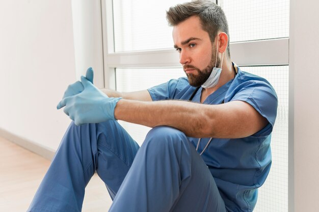 Male nurse wearing surgical gloves