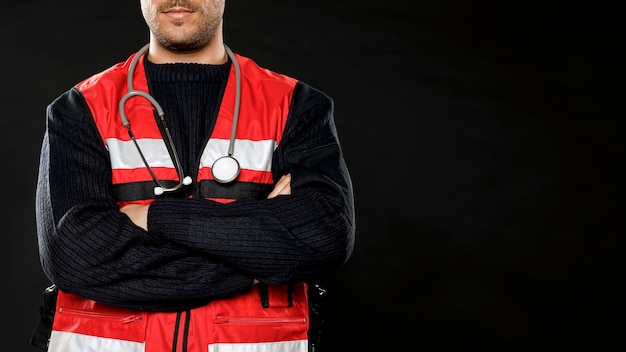 Free photo male paramedic with stethoscope and copy space