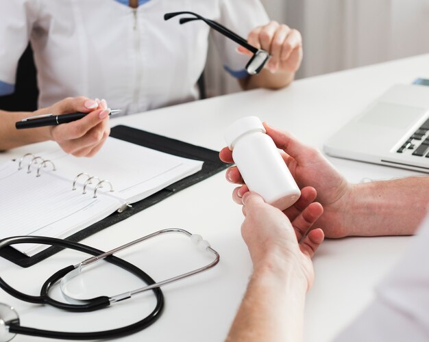 Male patient hands holding pills