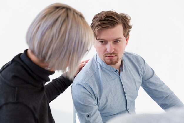male patient looking at rehab doctor