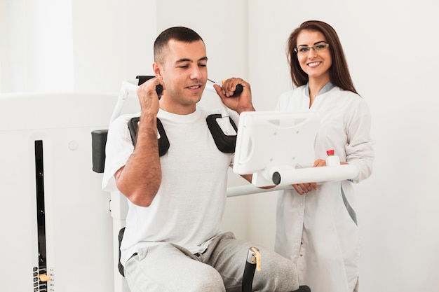 Male patient working on medical machine