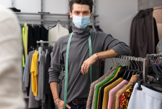 Free photo male personal shopper with mask working