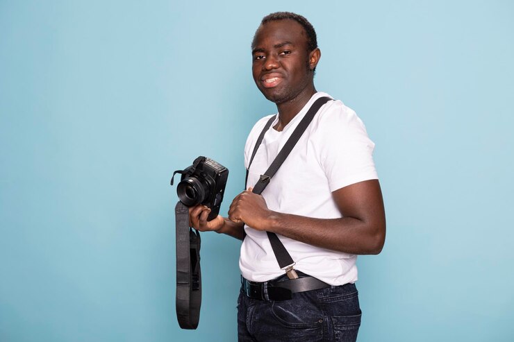 Free Photo male photographer posing with a camera