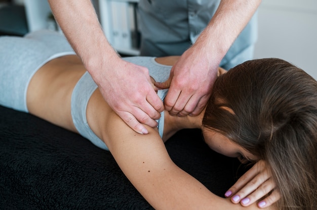 Male physiotherapist and woman during a physical therapy session