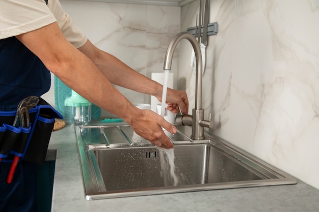 Male plumber working to fix problems at client's house