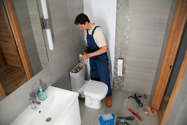 Free photo male plumber working to fix problems at client's house