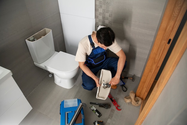 Male plumber working to fix problems at client's house