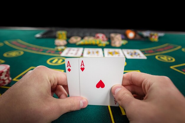 Free photo male poker player holding the of two cards aces