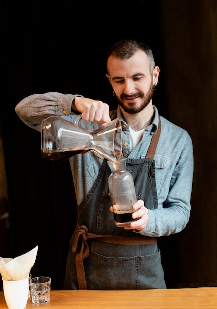 Male preparing coffee for customers