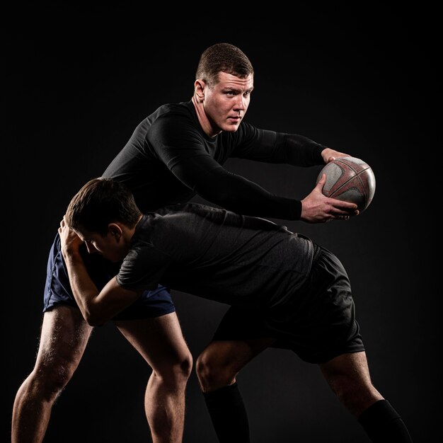 Male rugby players playing with ball