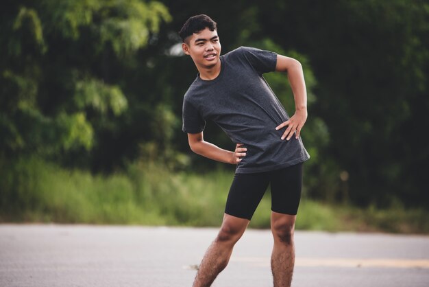 Male runner doing stretching exercise, preparing for workout